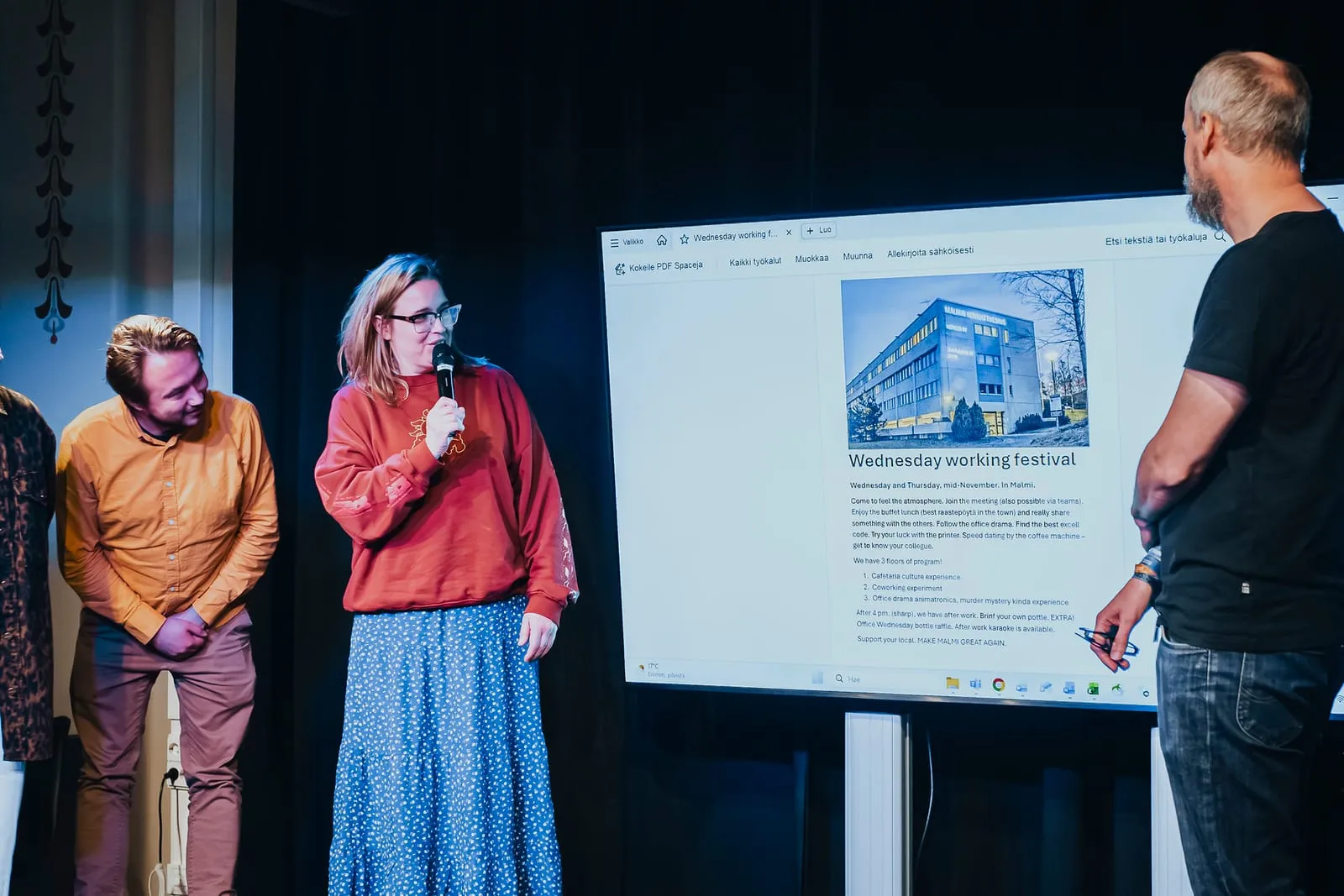 Four people presenting beside a big screen at the Creative x Tech evening at Maria 01