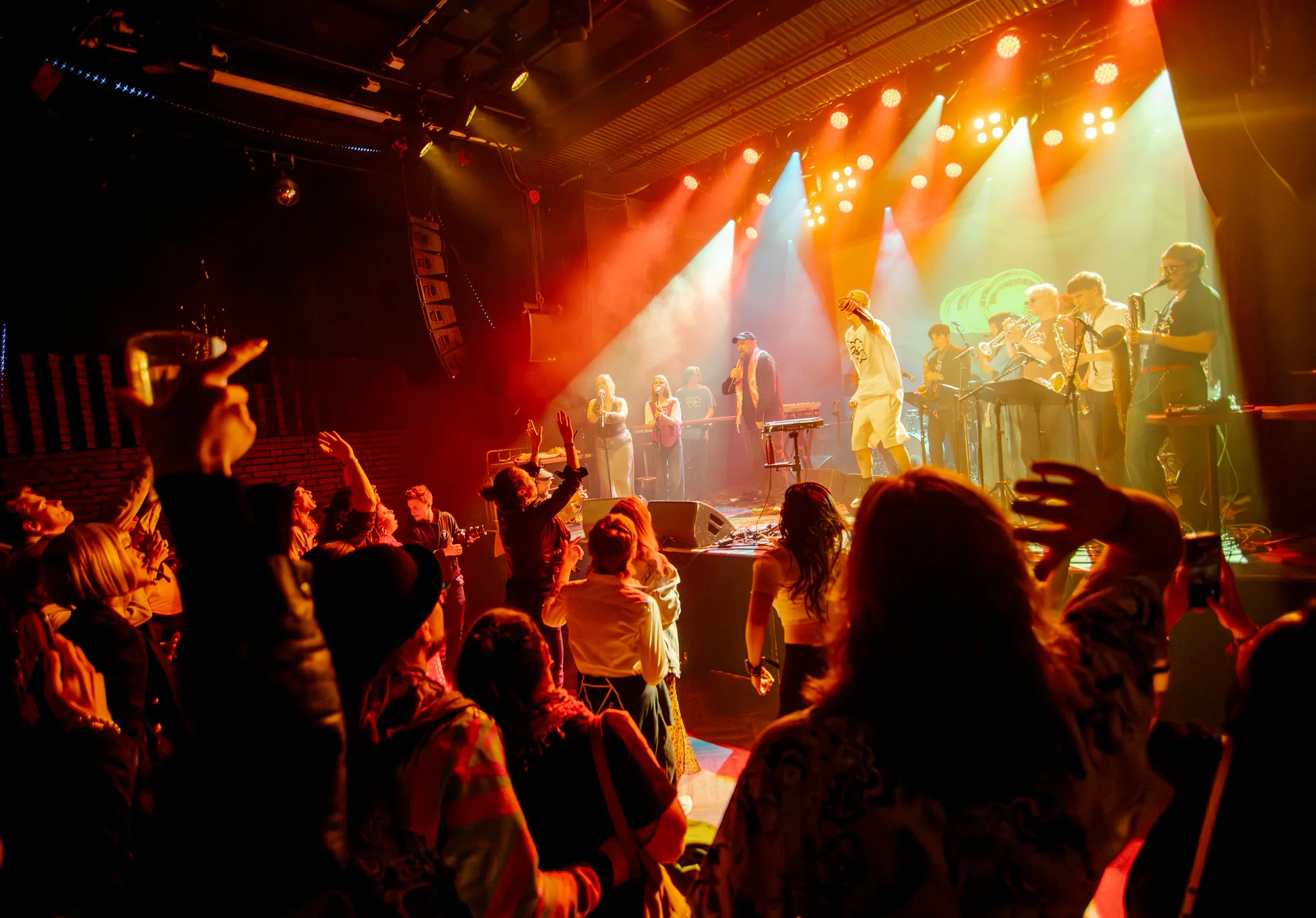 The crowd at Tavastia filling the floor in front of a red and orange stage