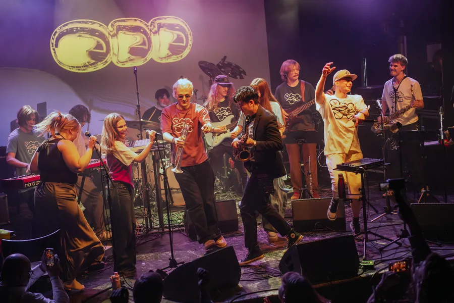 More than twenty musicians and dancers spread across the stage