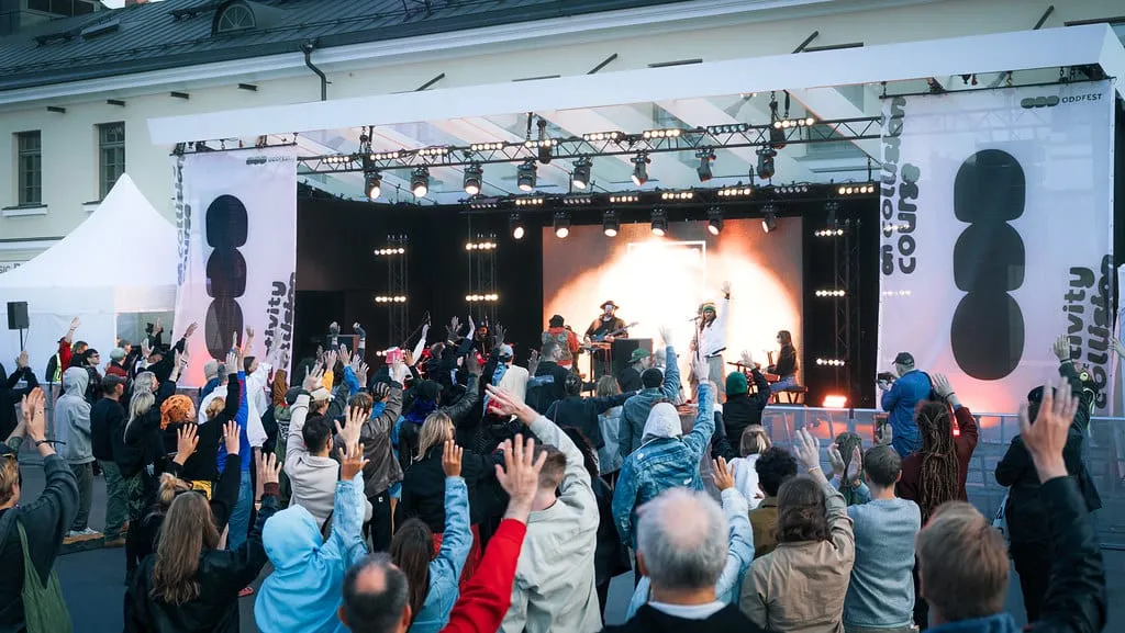 A crowd with hands in the air in front of the ODDfest 2025 main stage