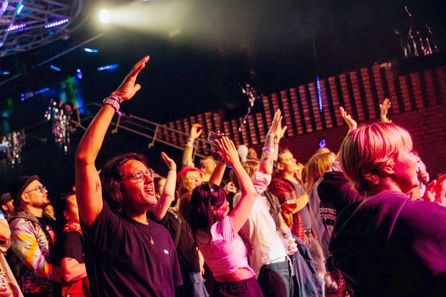 A packed crowd with hands in the air at Tavastia