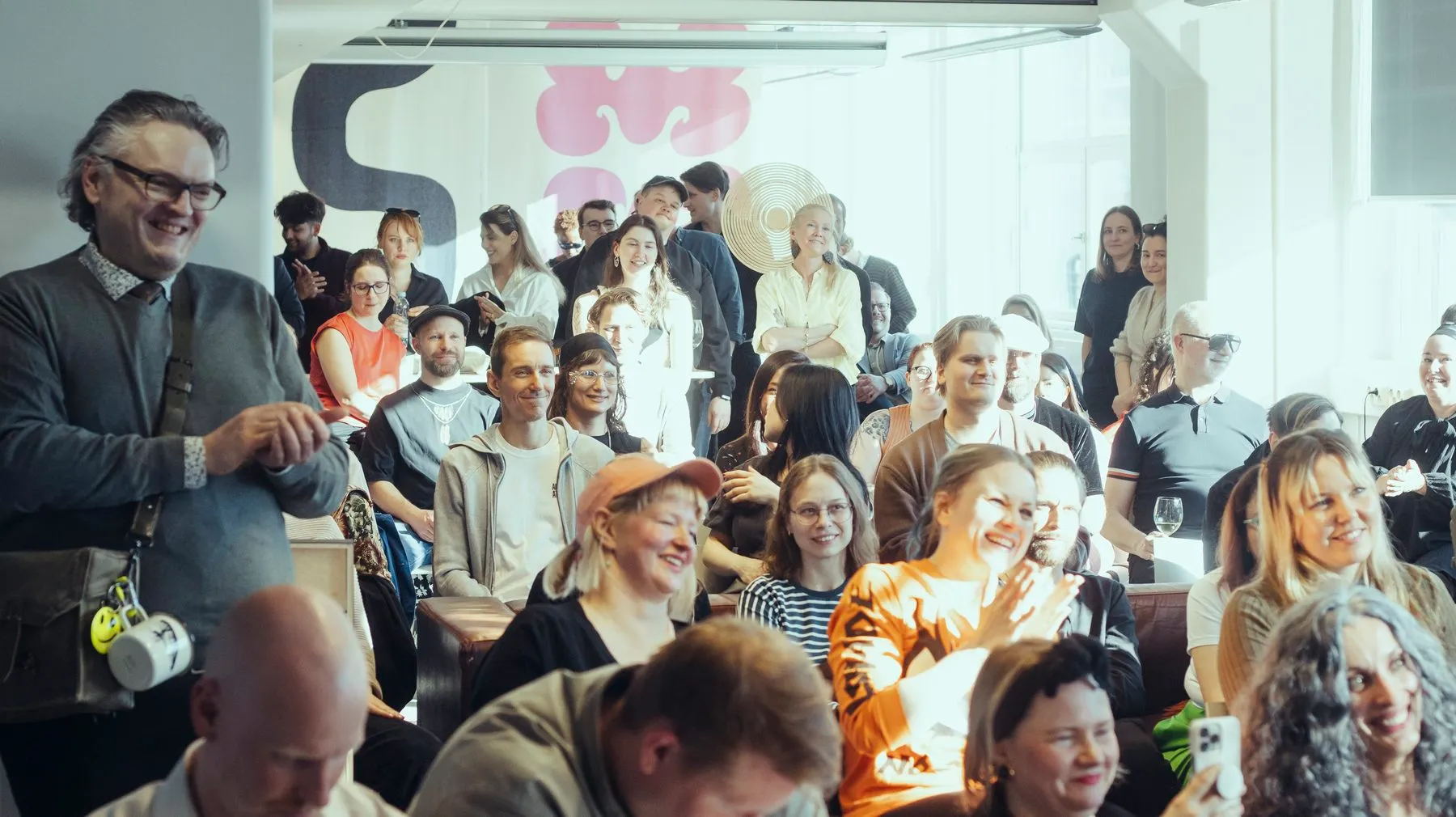 An audience laughing during a talk at the ODDspace opening
