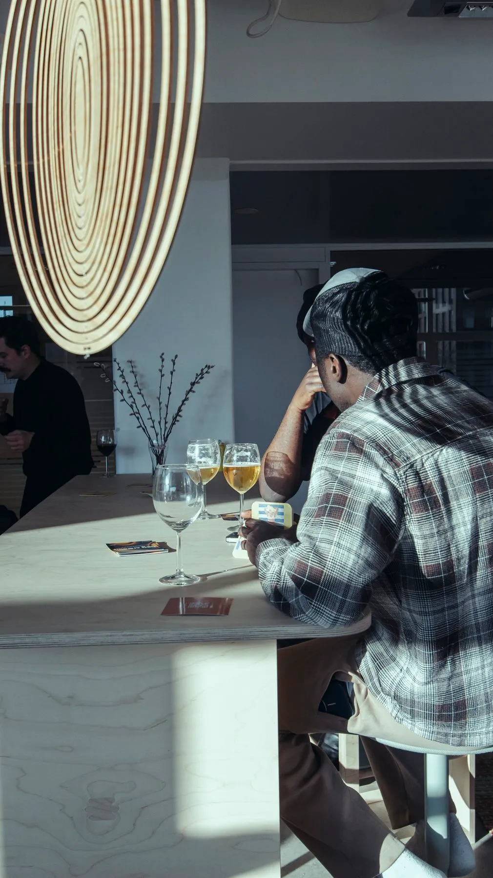 A guest sitting at a bar table with drinks